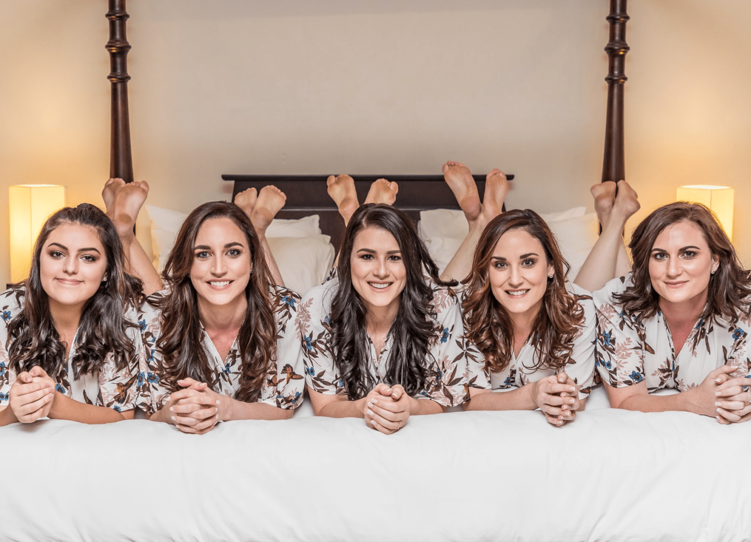 Bridesmaids relaxing on the bed in the bridal suite at Usambara Lodge