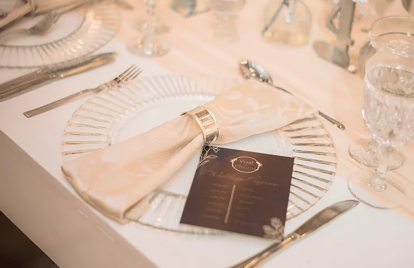 A close-up of a place setting with a menu card at Usambara Venue