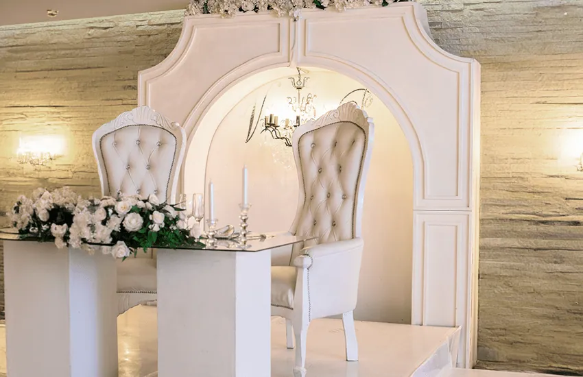 The bridal table and upholstered chairs in the Magali venue at Usambara Venue