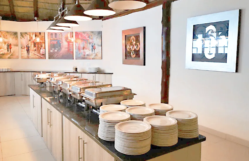 The buffet service counter set with stacked plates at Usambara Venue