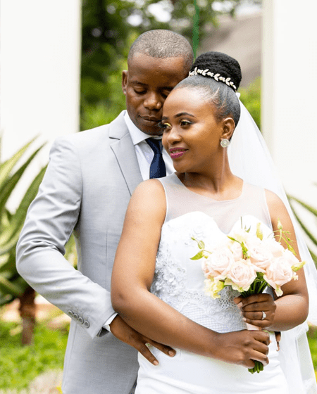 A newly married couple embracing in the gardens at Usambara Venue