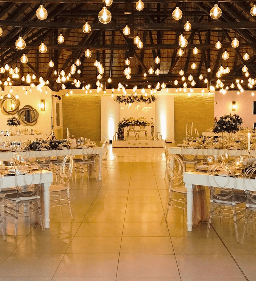 The Magali reception venue at Usambara Venue set with long tables under festoon lighting
