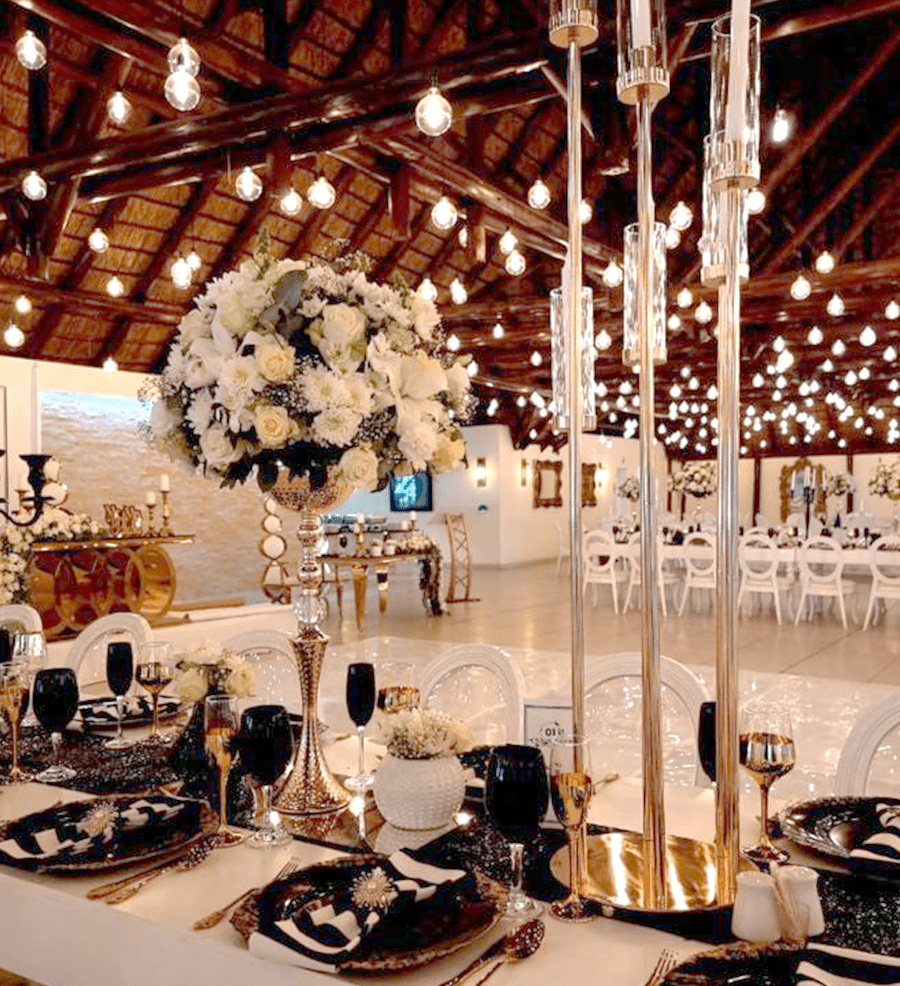 A black and white table setting with white florals in the Mponde venue at Usambara Venue